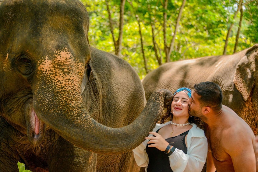 An elephant with a human and a child in a forested area. 5