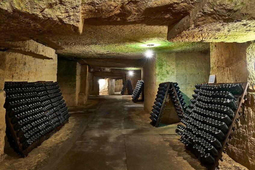 A cave with stone walls and a dimly lit passageway. 4