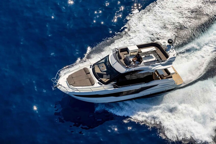 A speedboat with a wake, surrounded by deep blue water. 1