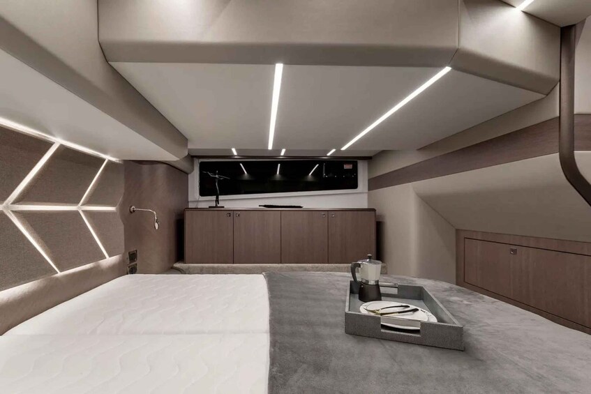 A modern bedroom with a bed, a TV, and a coffee table. 3