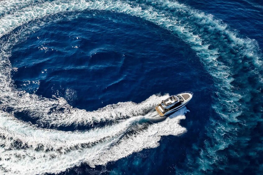 A boat creating a circular wake in the ocean. 4