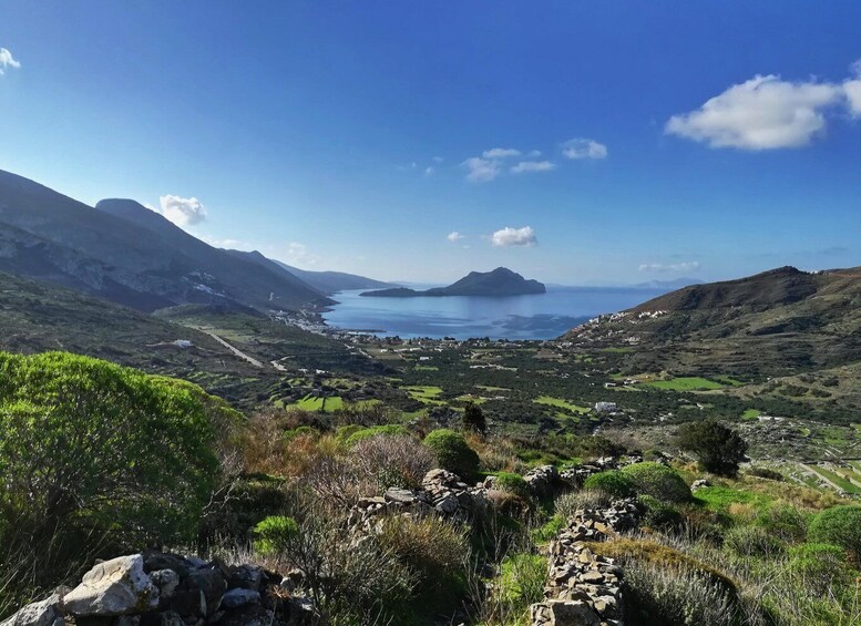 A coastal landscape with mountains, a small island, and a village. 3