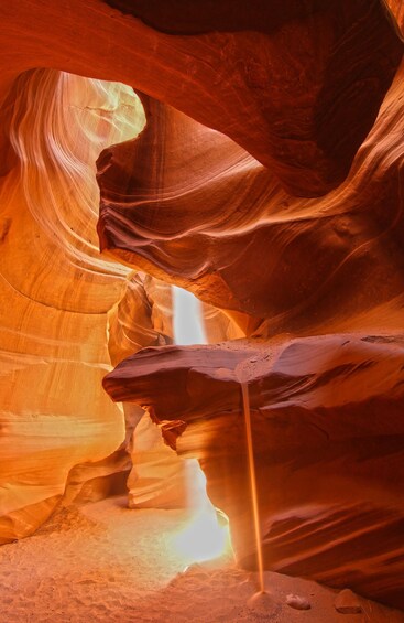 A canyon with smooth, curved sandstone walls and a narrow passageway. 4