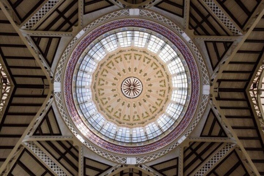 A circular architectural structure with a central design and radiating beams. 2