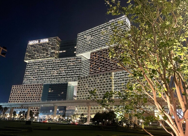 A modern building complex with illuminated signage at night. 4