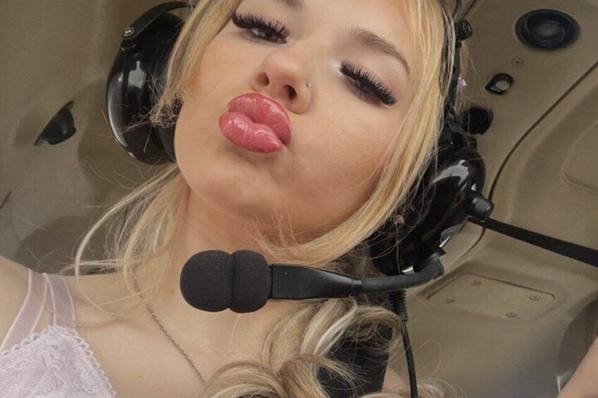 A person in a headset, likely in a control room or cockpit. 1