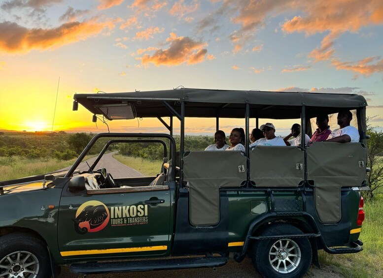 A safari vehicle with passengers, a sunset in the background, and a grassy landscape. 3