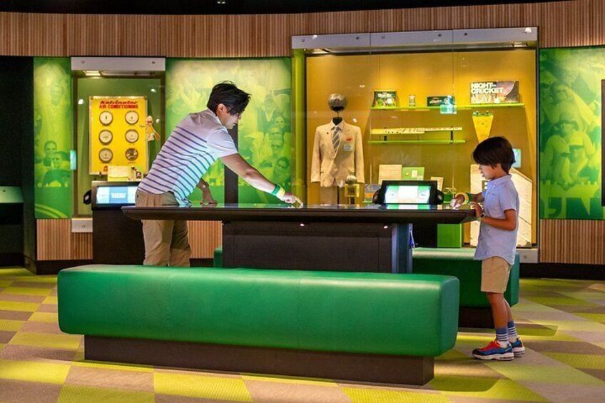 A man playing pool at a table with a child standing nearby. 2