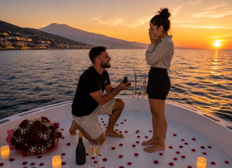 A couple on a boat at sunset with a bouquet of roses, champagne, and candles. 1