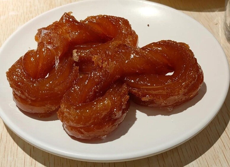 A plate of glazed donuts. 4