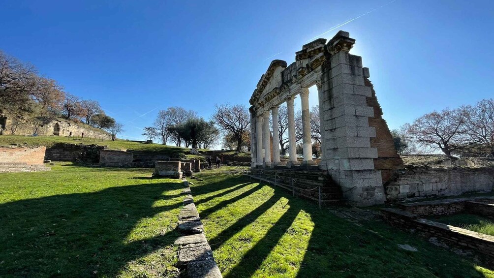 Ancient ruins with columns and a stone pathway. 2
