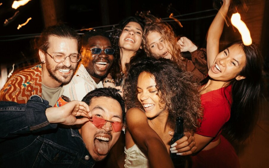 A group of people at a social event with a warm, ambient light setting. 4
