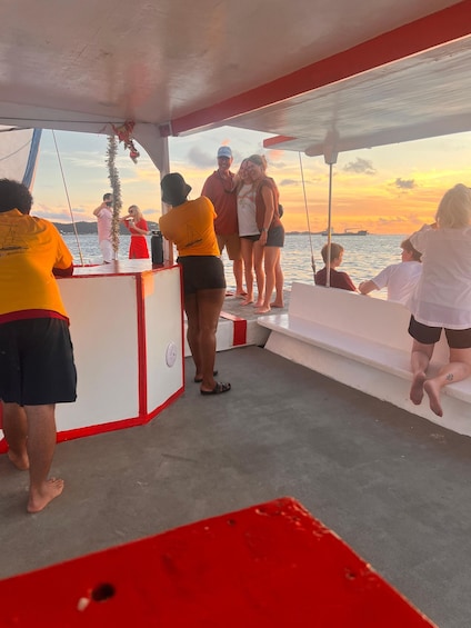 A group of people on a boat during sunset. 5