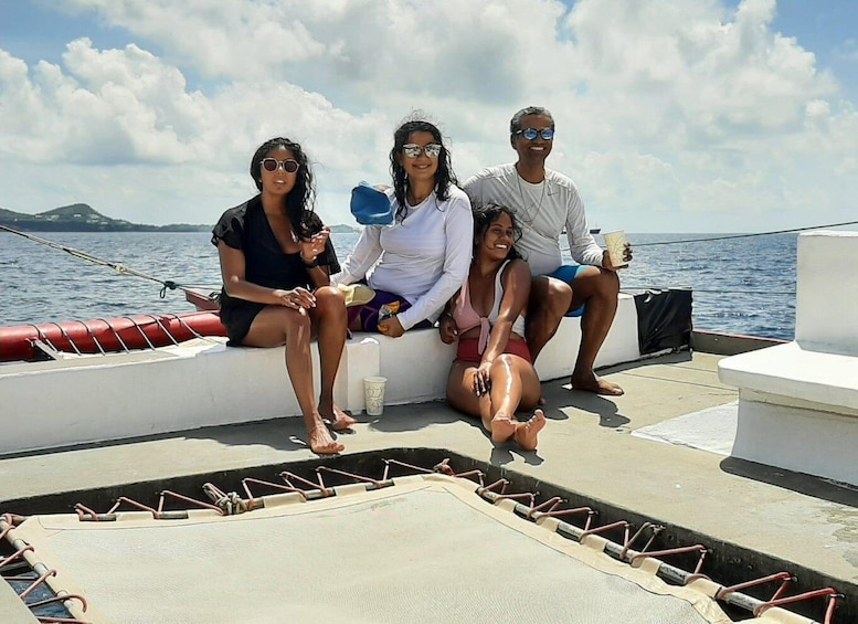 A group of people on a boat with a clear sky and calm sea. 3