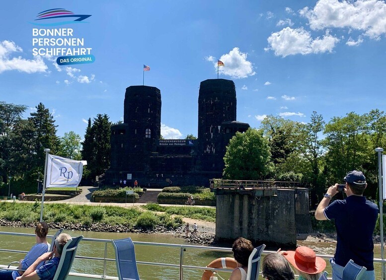 A castle with two towers, a flag, and a sign for the Friedensmuseum. 1