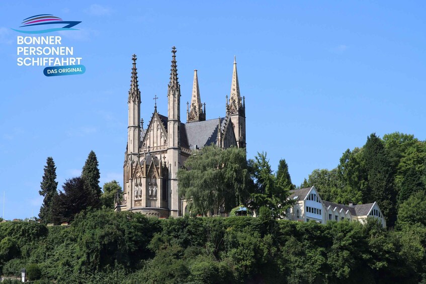 A Gothic-style church with multiple spires and a white building in the foreground. 4