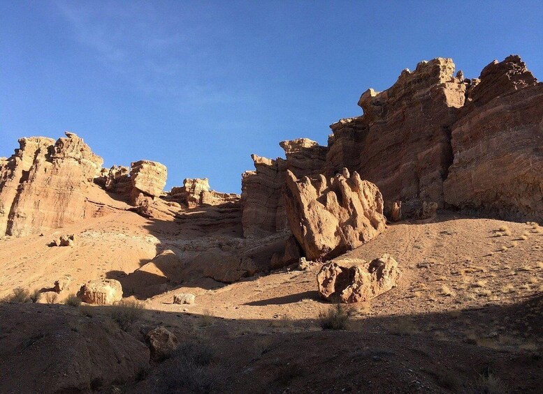 A desert landscape with prominent rock formations and sparse vegetation. 2