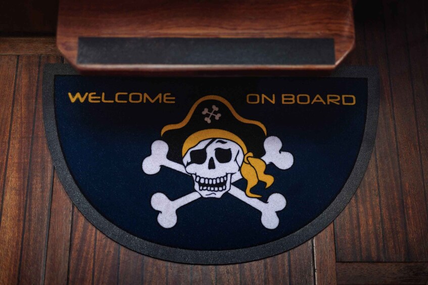 A welcome mat with a skull and crossbones design and the text 'WELCOME ON BOARD'. 2