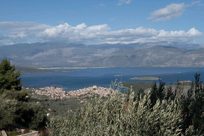 A coastal town with a view of the sea and mountains in the distance. 1