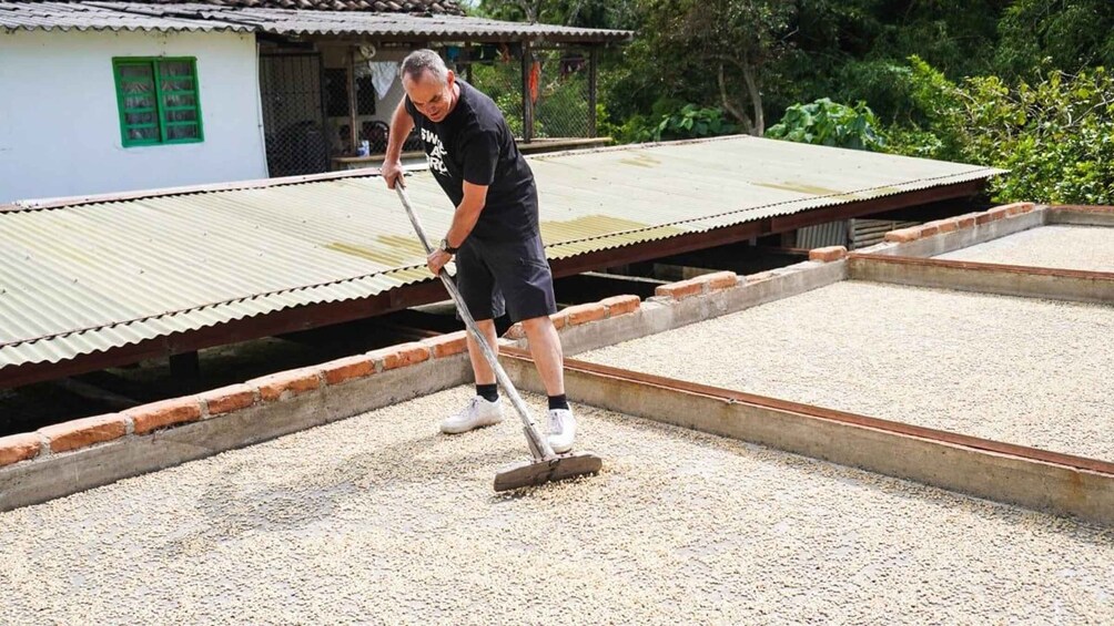 A person sweeping gravel on a rooftop. 2