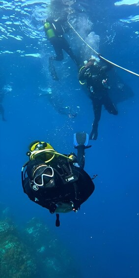 Two scuba divers underwater with their equipment. 5