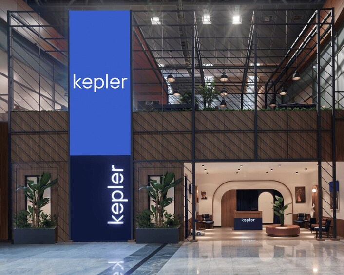 A modern interior with a prominent blue and white sign reading 'kepler.' 1