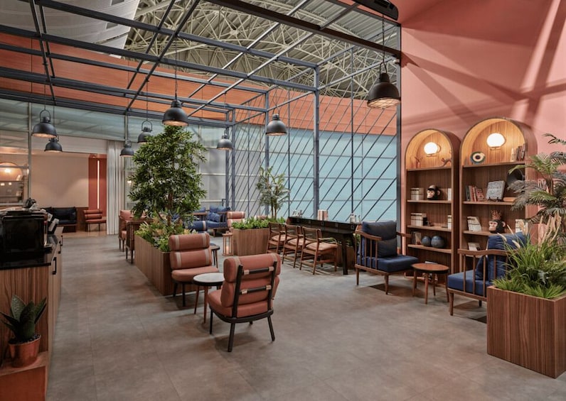 A modern interior with seating, plants, and bookshelves. 4