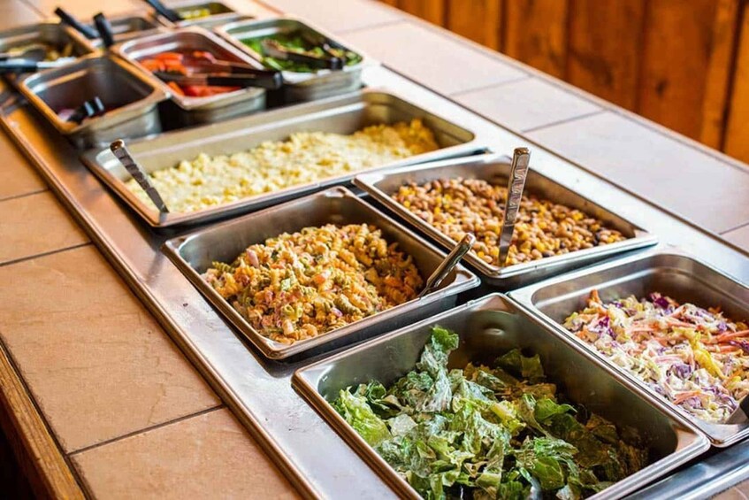 A buffet with various dishes including pasta, rice, and salads. 5