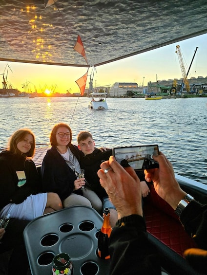 A group on a boat with a sunset in the background. 5