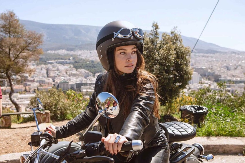 A person on a motorcycle with a cityscape in the background. 3