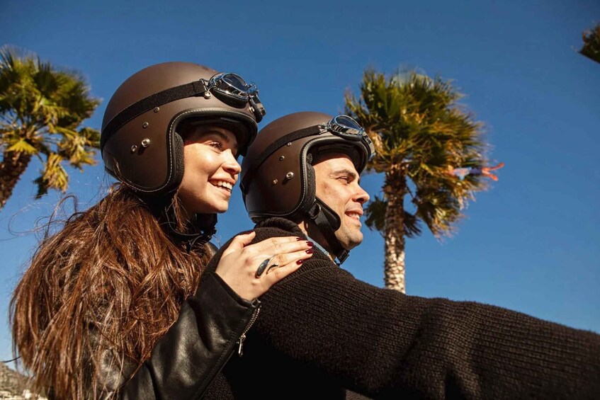 Two people wearing helmets, one with a ring, and palm trees in the background. 5