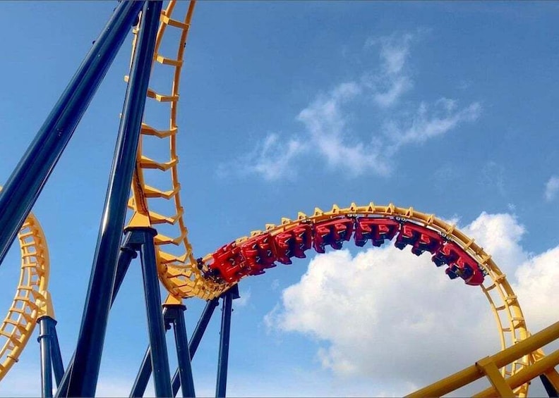 A roller coaster track with a steep drop and a curved section. 1