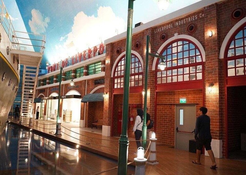 A museum exhibit with a brick building labeled 'LIVERPOOL INDUSTRIES Co.' and a ship model. 5