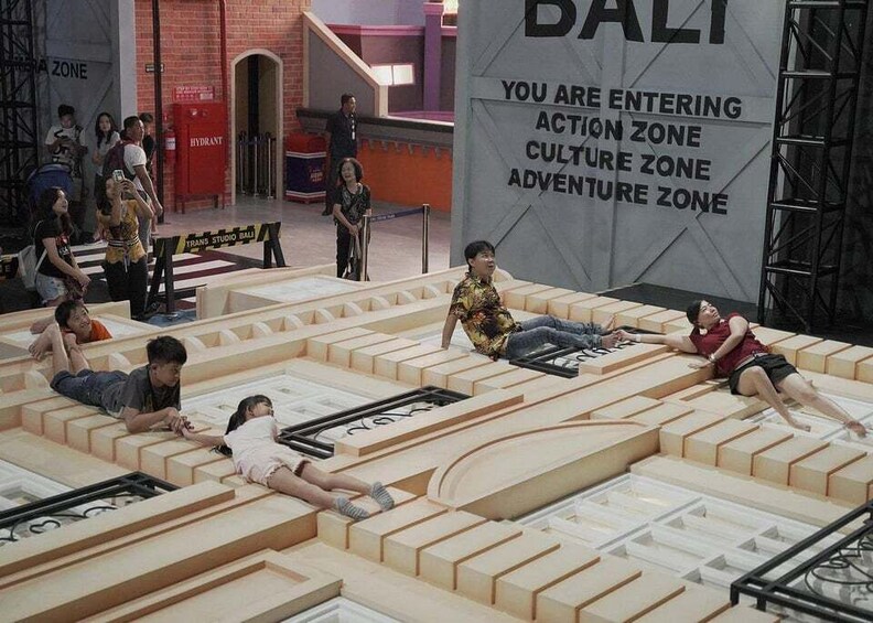 A maze with people navigating it, and a sign indicating different zones like Action, Culture, and Adventure. 5
