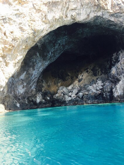 A cave entrance with turquoise water. 2