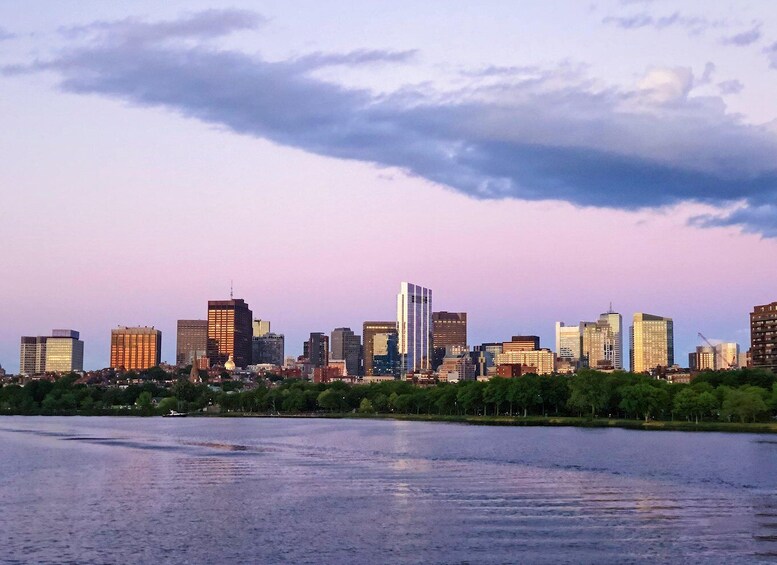 A city skyline with modern buildings and a river in the foreground. 5