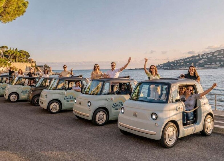 Vintage cars parked by the seaside with people inside. 5