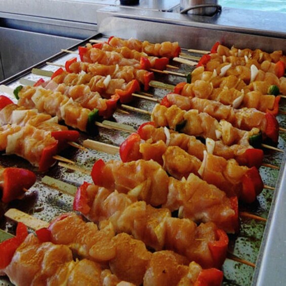 Skewers of grilled shrimp and vegetables on a grill. 2