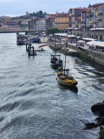 A harbor with boats, a bridge, and colorful buildings along the waterfront. 2