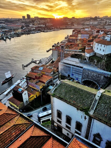 A river with boats, a bridge, and buildings with red-tiled roofs. 4