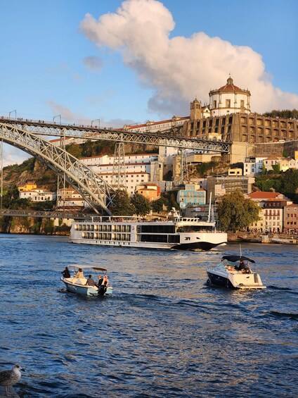 A river with boats, a bridge, and a historic building in the background. 3