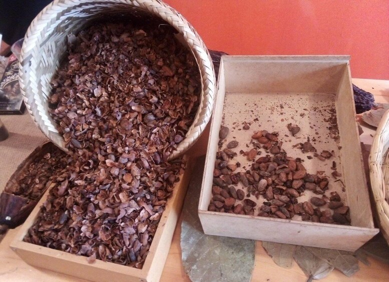 A wooden box and a woven basket filled with coffee beans. 5