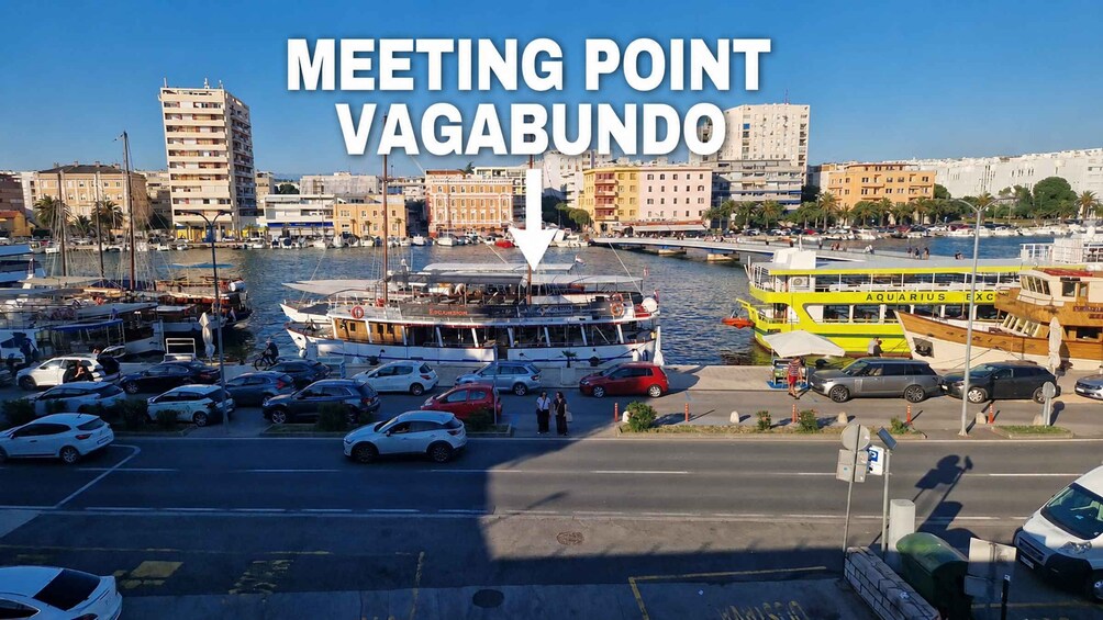 A marina with boats, a yellow ferry, and a cityscape with buildings. 2