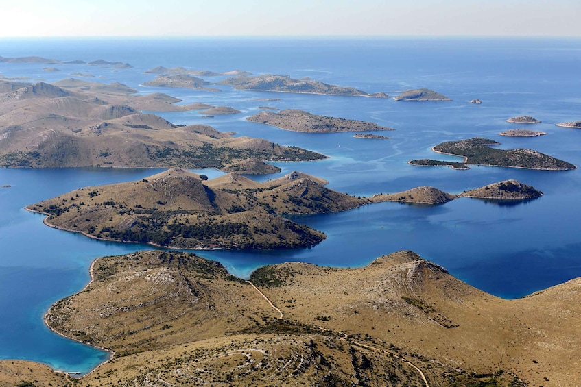 A coastal landscape with numerous small islands surrounded by clear blue waters. 4