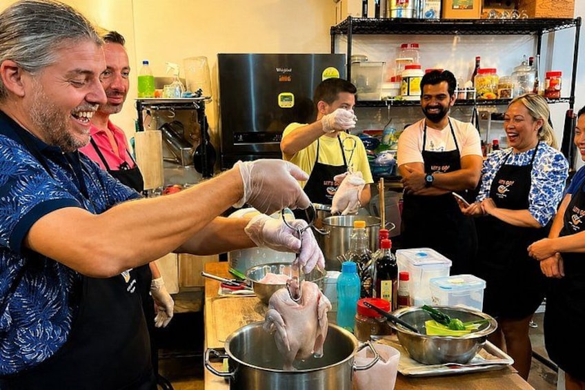 A group of people preparing food in a kitchen. 1