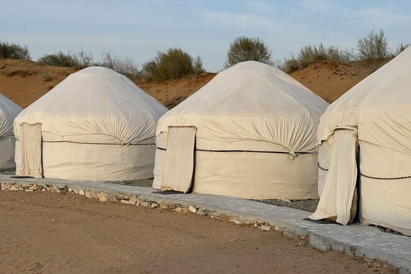 A row of covered tents in a desert setting. 5