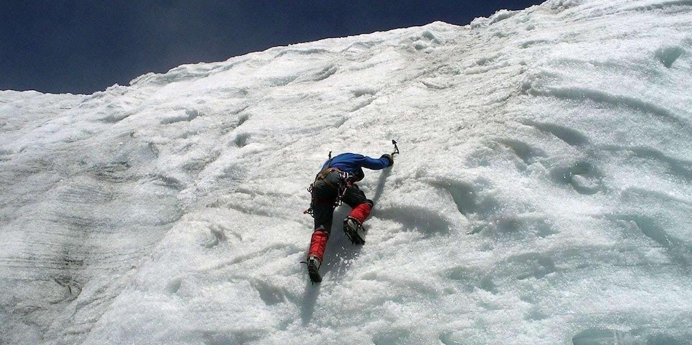 A person climbing a steep, snow-covered mountain. 3