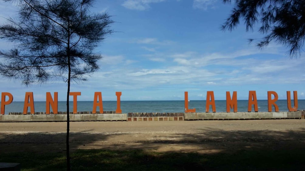 A beach with the words 'PANTAI LAMARU' in large letters. 2
