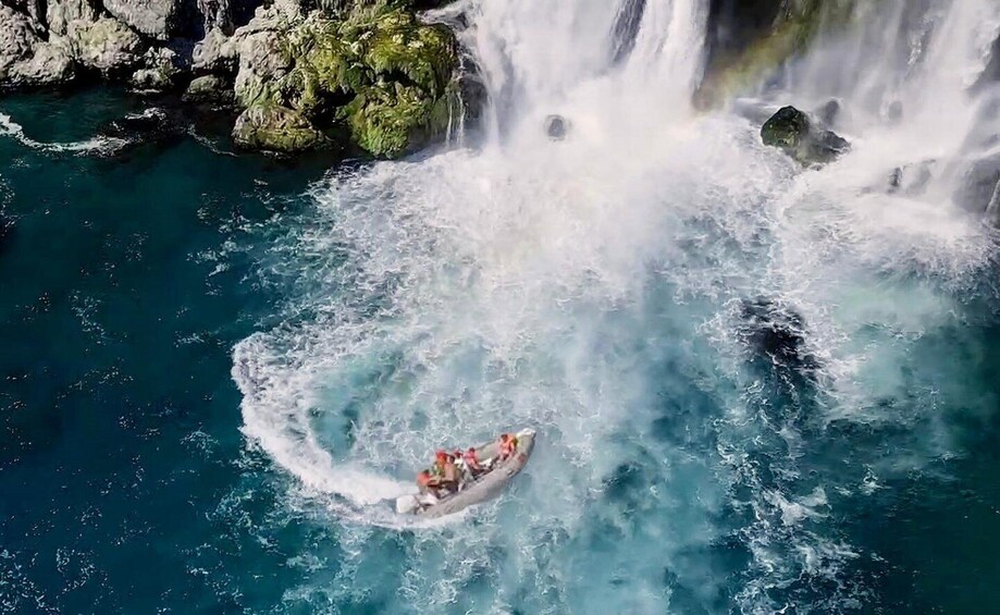 A raft navigating a turbulent waterfall. 1
