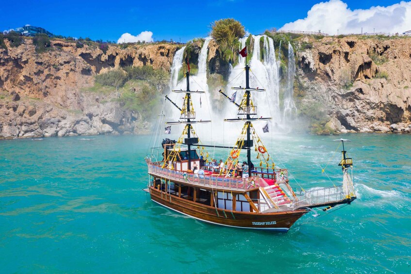 A boat named 'Freedom Delray' with a waterfall in the background. 4
